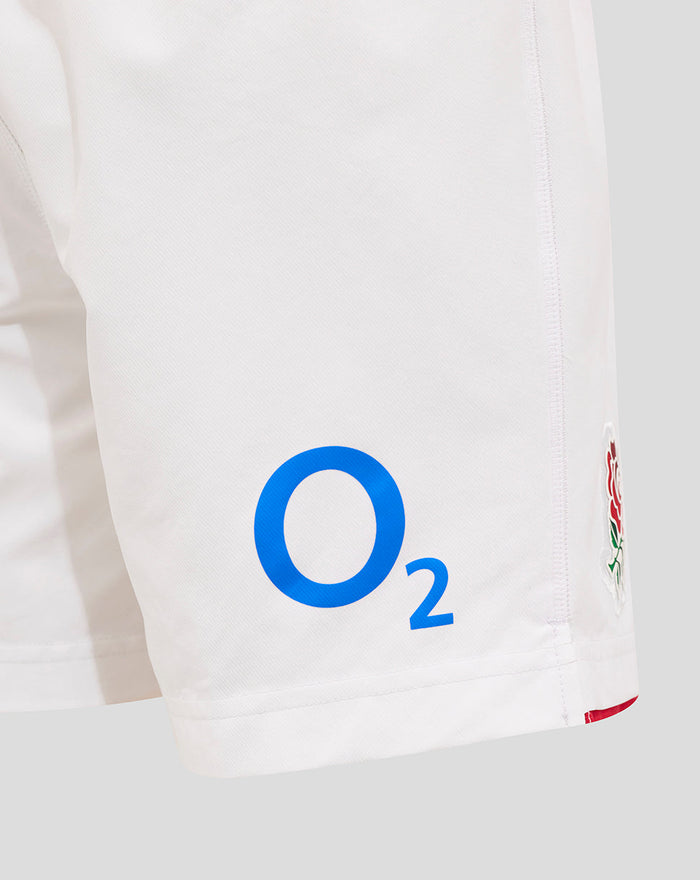 Close-up of white shorts with blue O2 logo on the leg and partial rose crest at the hem