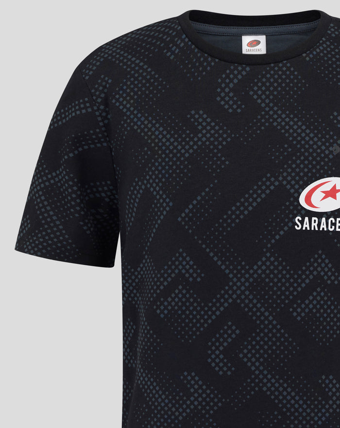 Close-up of dark navy T shirt with blue geometric print across the chest and sleeves