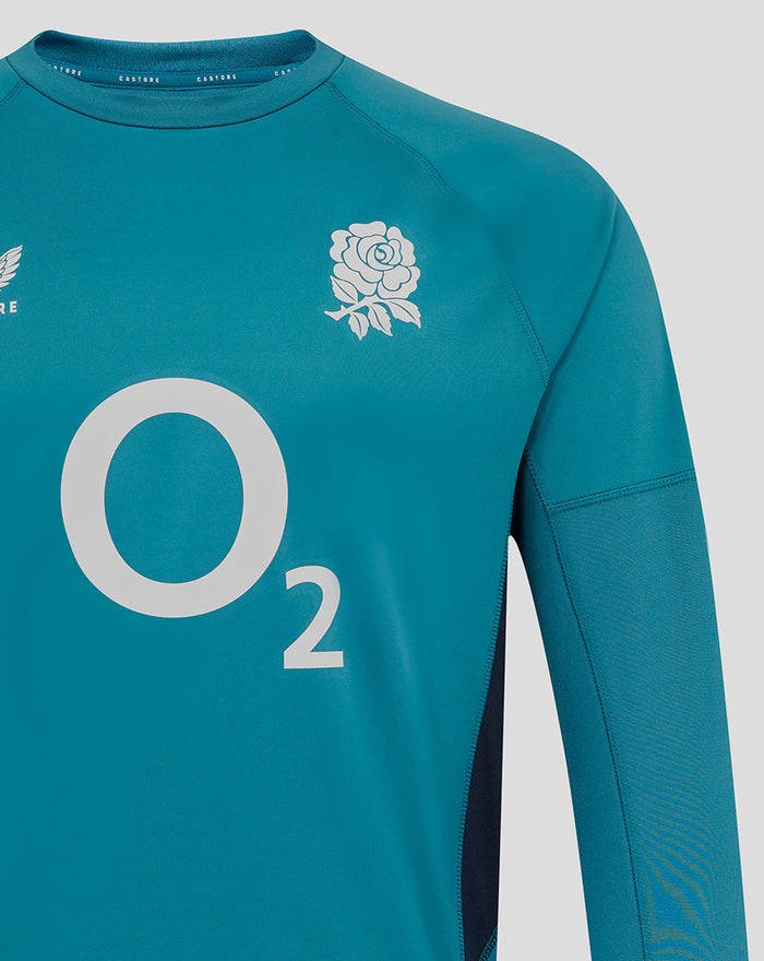 Storm blue rugby drill top close-up featuring rose crest on chest and Castore emblem near the shoulder with a bold O2 graphic across the front.