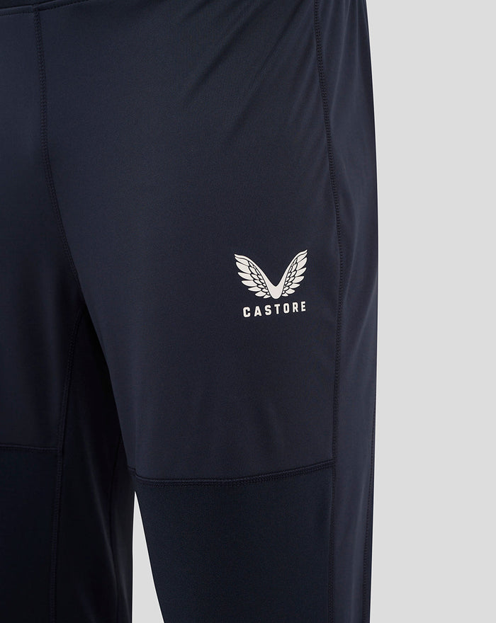 Navy England Rugby drill pants close-up showing rose crest, O2 and Castore logos on the thighs with panel stitching.