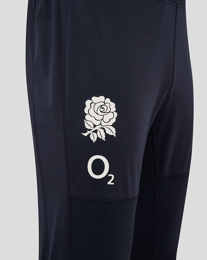 Close up of navy training pants thigh showing rose crest and O2 logo with turquoise side panel