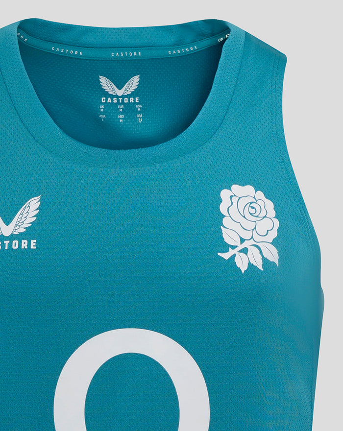 Close-up of the chest area on the storm blue England Rugby singlet showing the rose crest and Castore logo with part of the O2 sponsor visible.