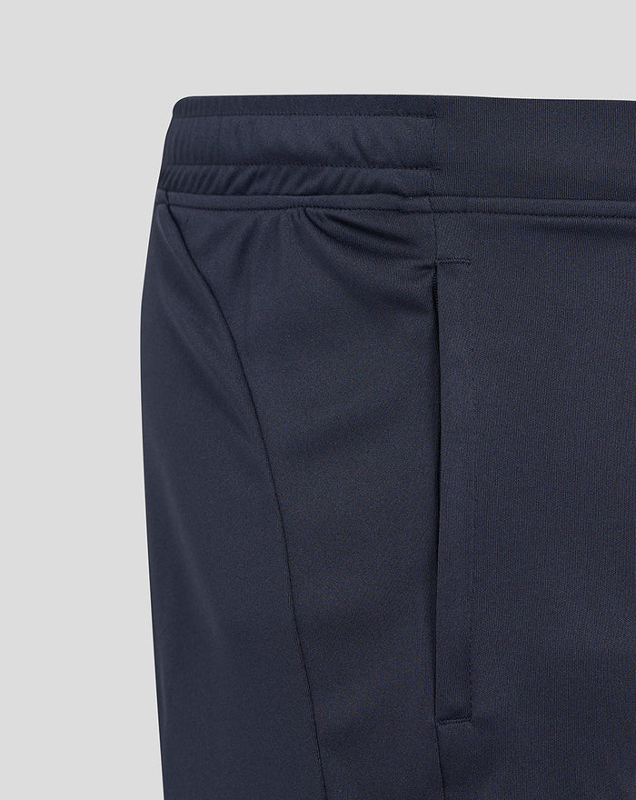 Close up of navy shorts with teal side panel and partial white rose design near the seam