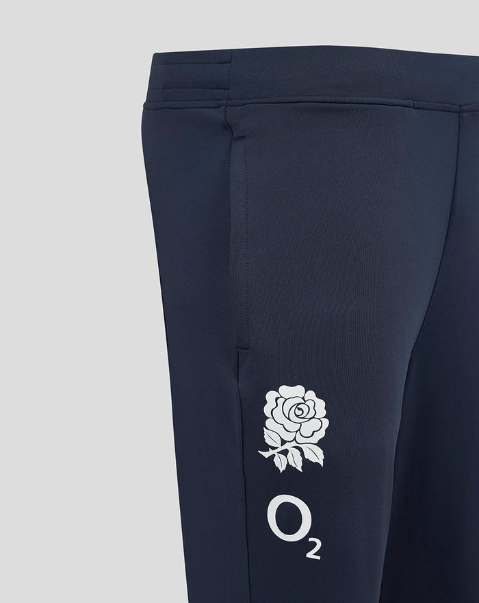 Close-up of navy knit pant leg showing white rose crest and O2 logo on the thigh