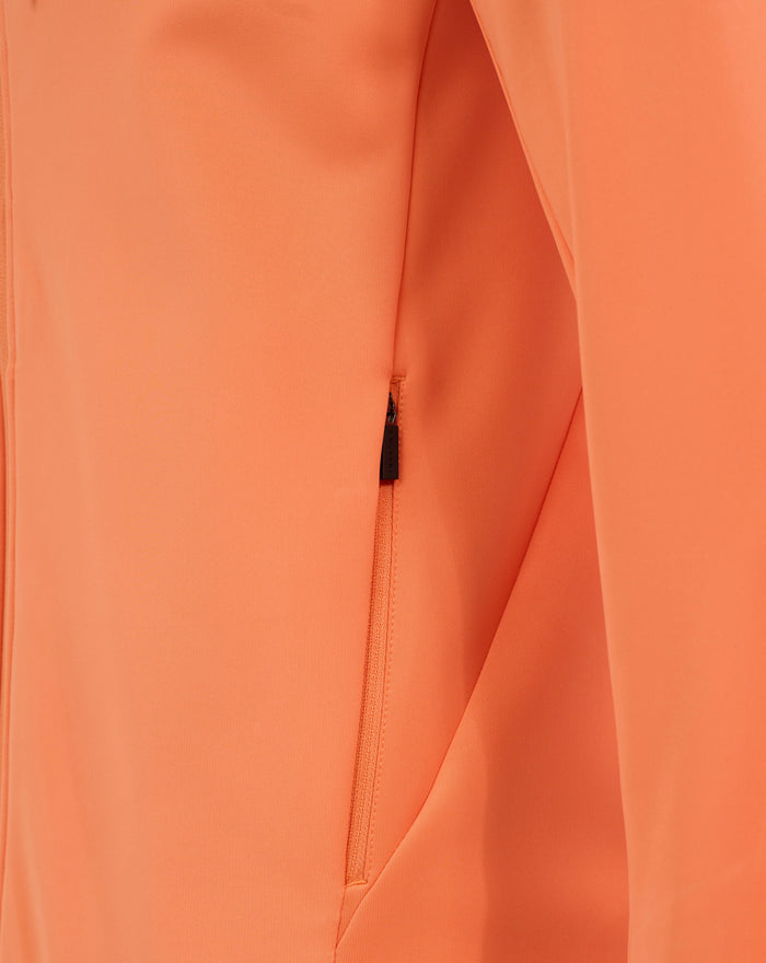 Close-up of melon orange fabric featuring a center front zipper and seam details on a rugby hoodie