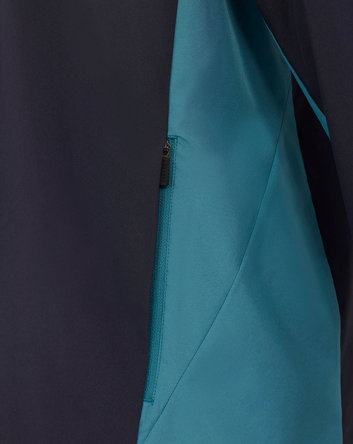 Close up of navy England Rugby performance jacket showing teal side panel and zip pocket