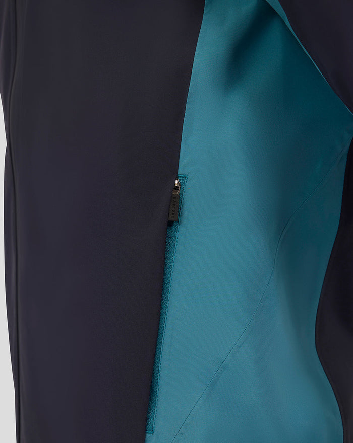 Close up of navy rain jacket showing teal interior panel along the zipper seam