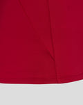 Close up of red fabric with stitched seams and curved hem from the England pre match drill top O2