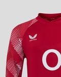 England pre match drill top in red with a geometric sleeve pattern and white crest on the chest