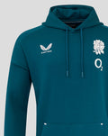 Close up of teal hoodie chest shows Castore logo on left and a white rose with O2 on the right.