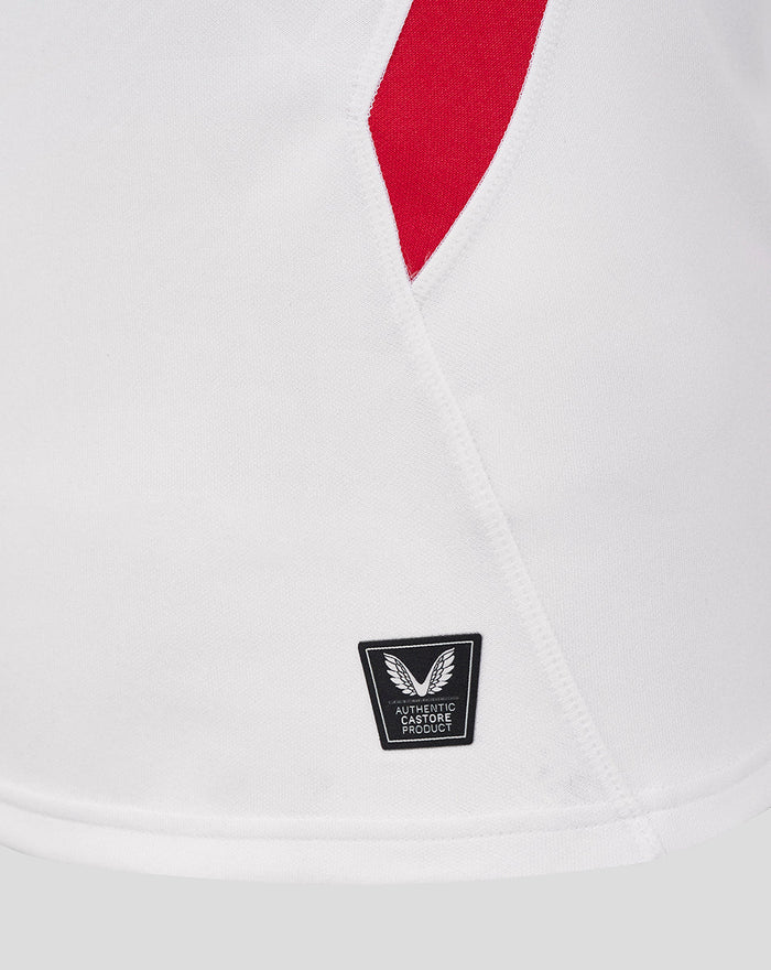 Close up of white England Rugby Home Pro shirt showing a red angled side panel and Castore authenticity badge near the hem.