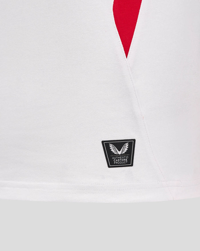 Close-up of the white England rugby shirt hem showing the Castore authentic product patch