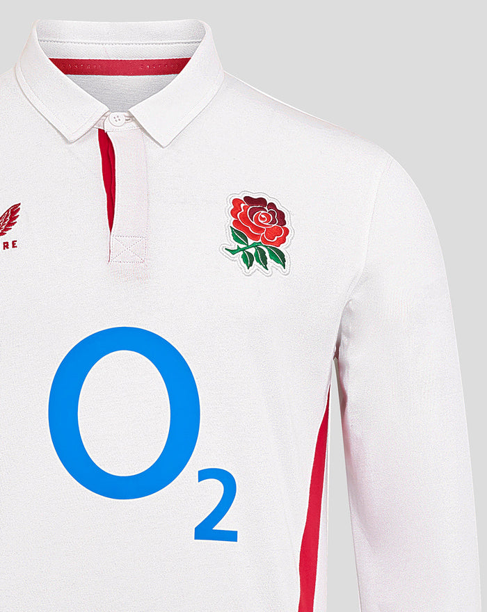 Close-up of chest on white England rugby shirt displaying O2 logo, rose crest, and red side panels