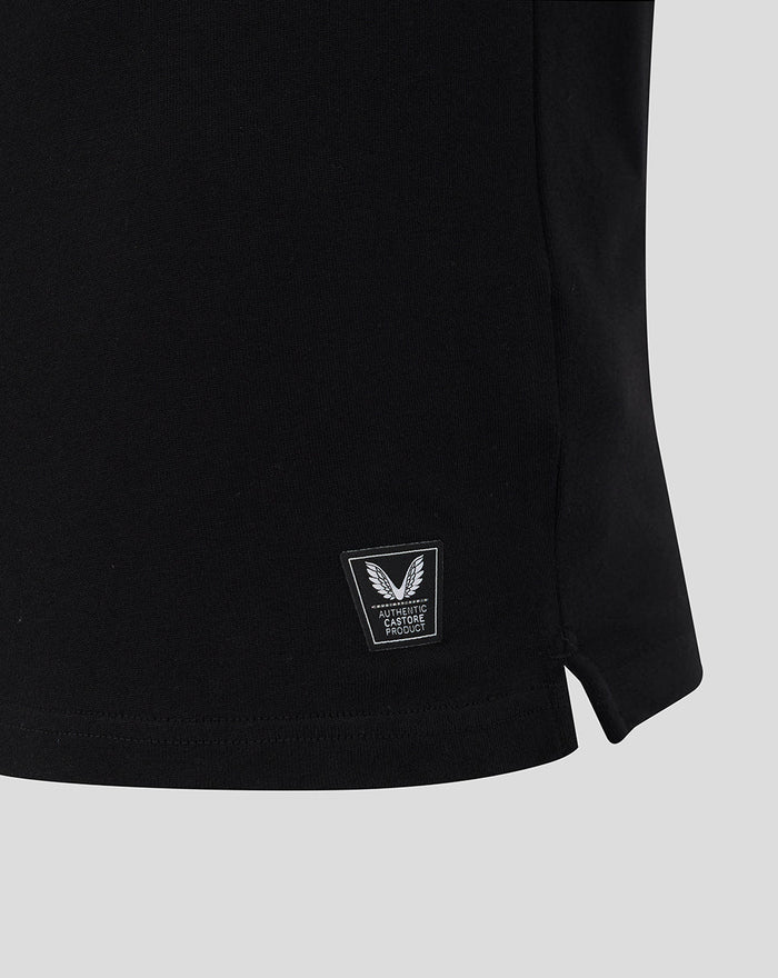 Hem view of black Castore rugby shirt with small authenticity badge near the bottom.