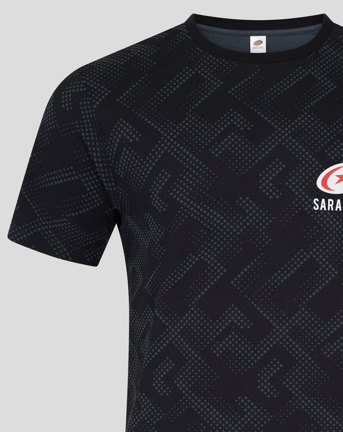 Front view of black patterned pajama top with a circular logo on the chest