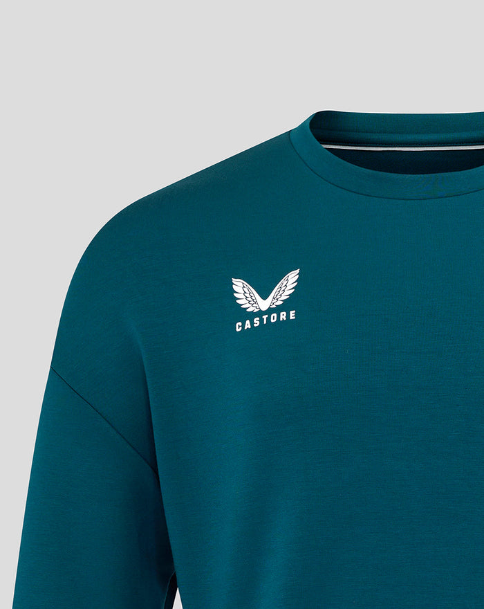 Close-up of teal Travel Crew Sweatshirt chest displaying Castore logo