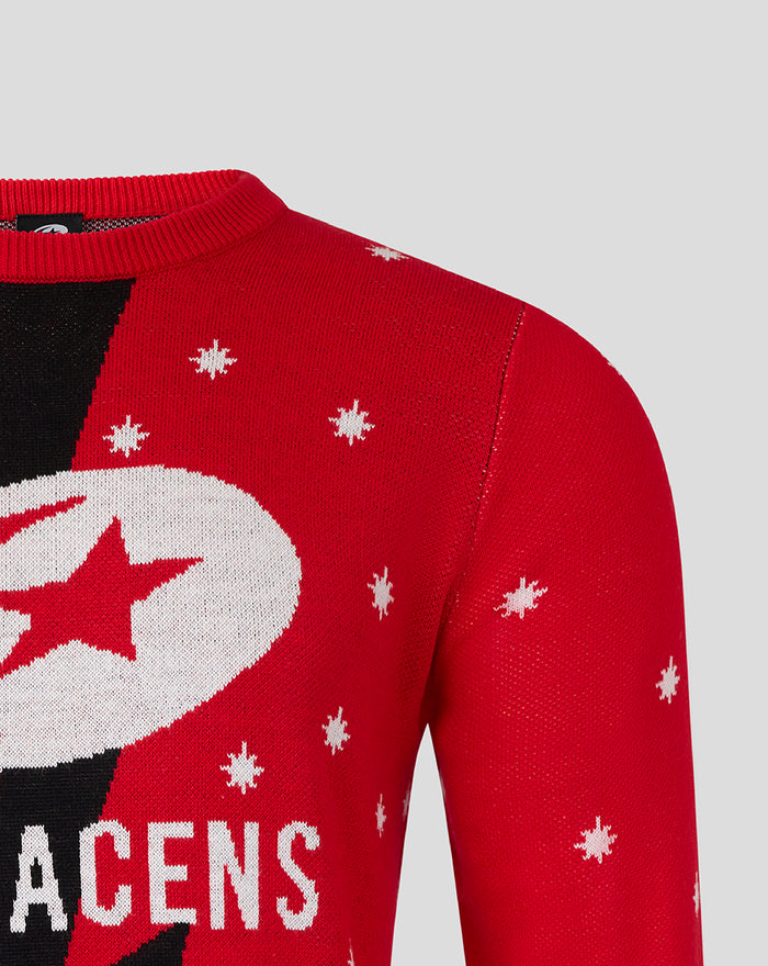 Adult size red Christmas jumper with white snowflakes, a large circular emblem featuring a star, and black diagonal panels.