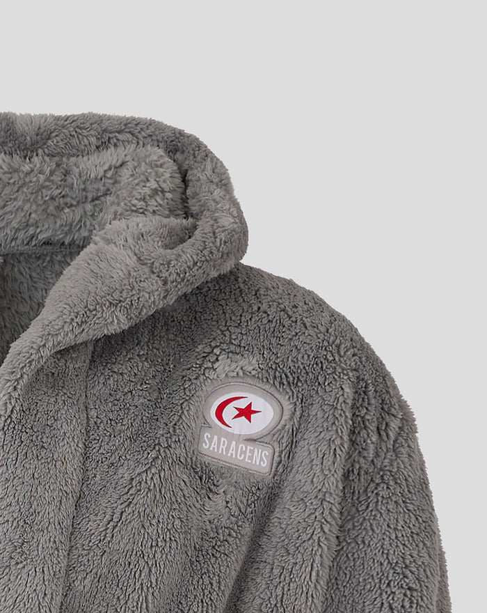 Close-up of the Saracens logo patch on the gray plush junior dressing gown.