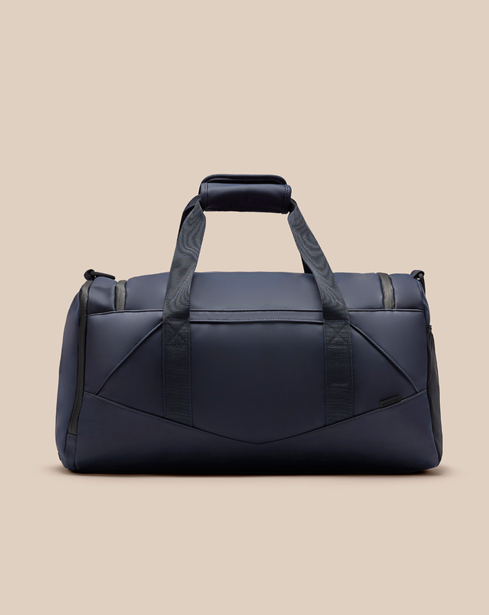 Navy CORE HOLDALL duffel bag with padded top handle and dual carrying straps