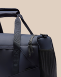 Close-up of navy CORE HOLDALL zipper and fabric with PROTEK branding