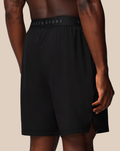 Back view of black shorts with an elastic waistband and a Castore wing logo near the hem
