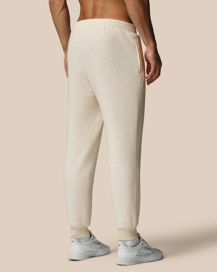 Back view of beige cotton fleece joggers with elastic waistband and side pocket