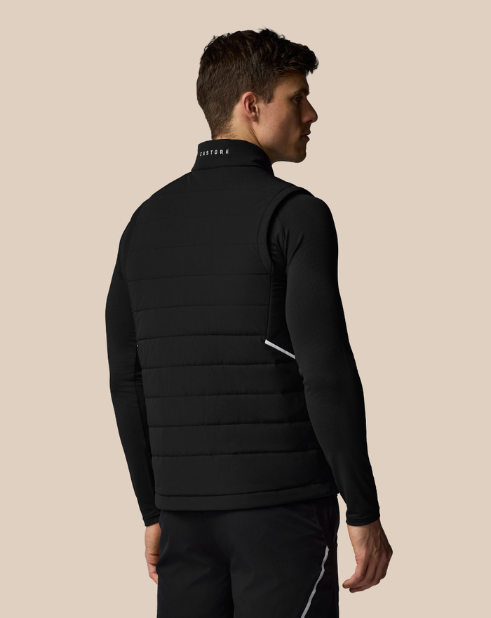 Back view of black quilted gilet with stand collar and CASTORE logo on the collar.