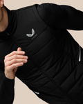 Close-up of the chest area on a black gilet showing the CASTORE logo and a diagonal zipper.